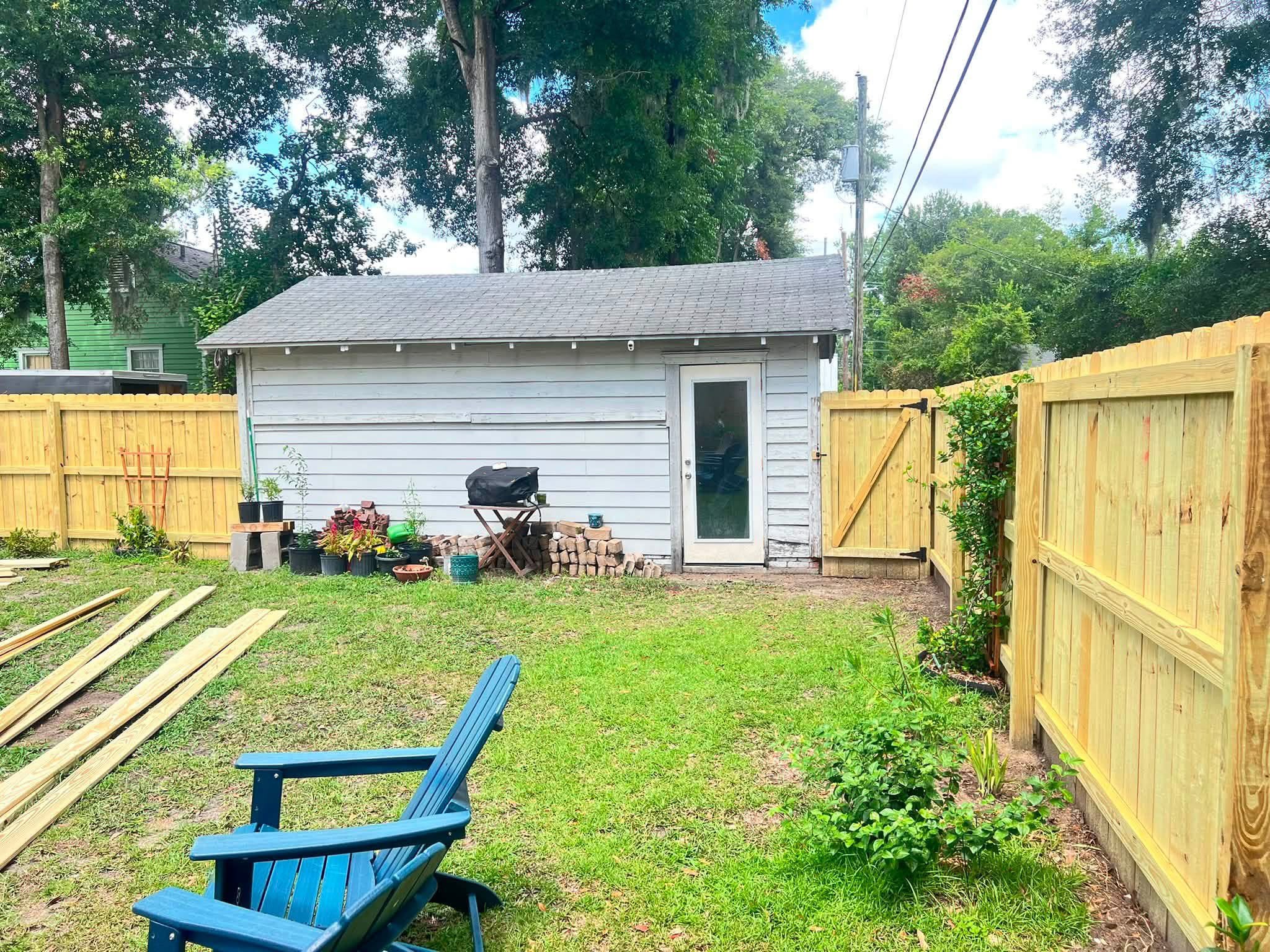 Finished backyard with fence, gate and planting beds