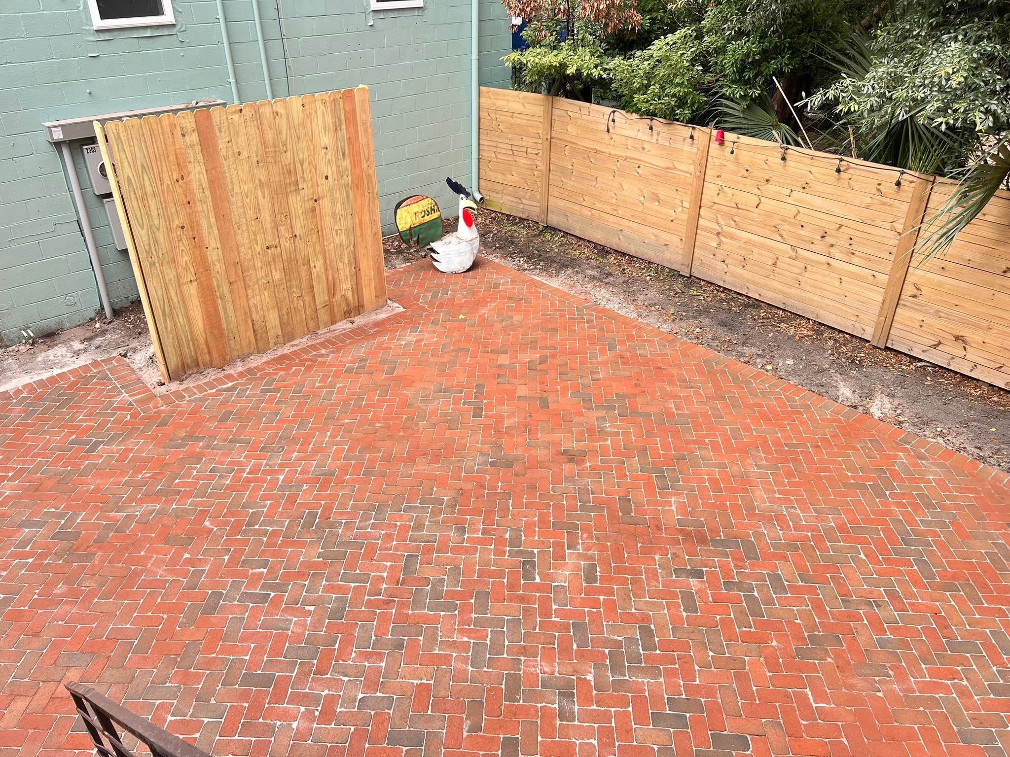 Brick courtyard finished up to a new wood privacy gate