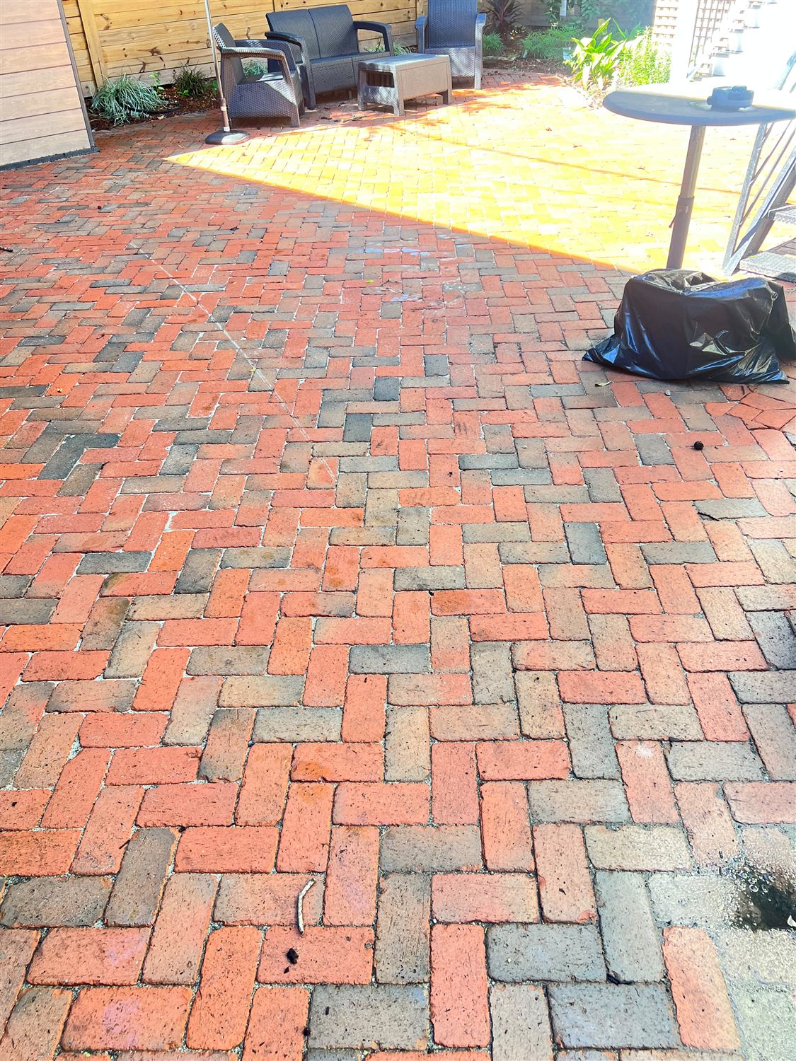 Reclaimed brick patio in herringbone in a Savannah courtyard, built by Lalo's Home Improvements