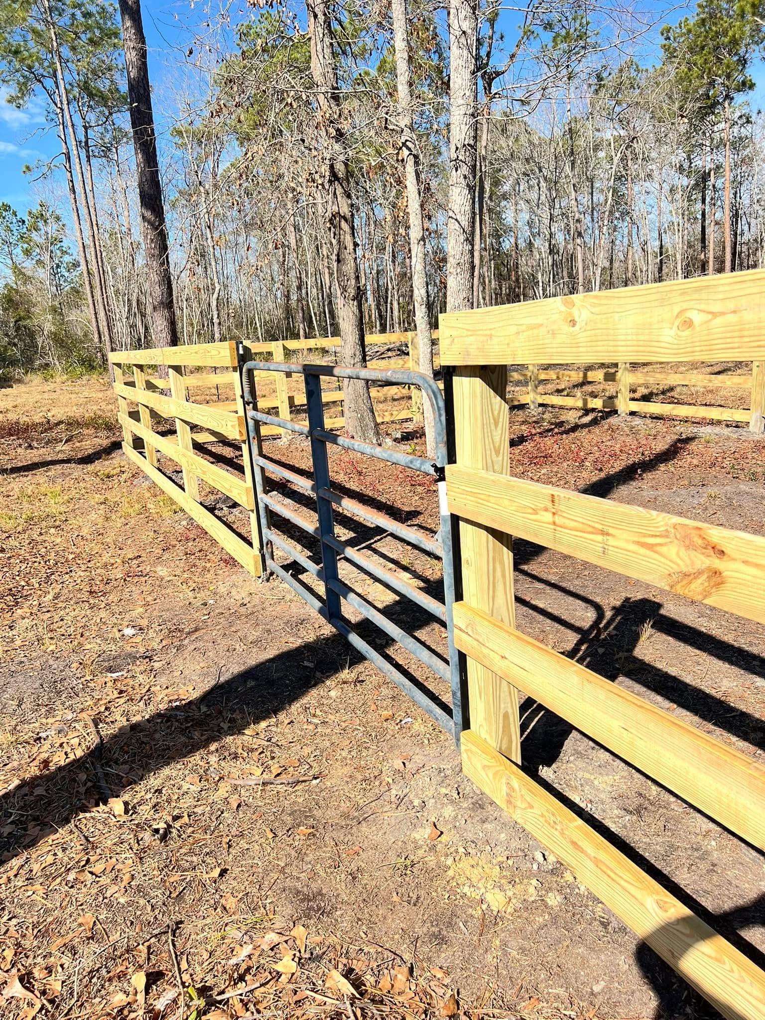 Ranch rail fence with a galvanized farm gate