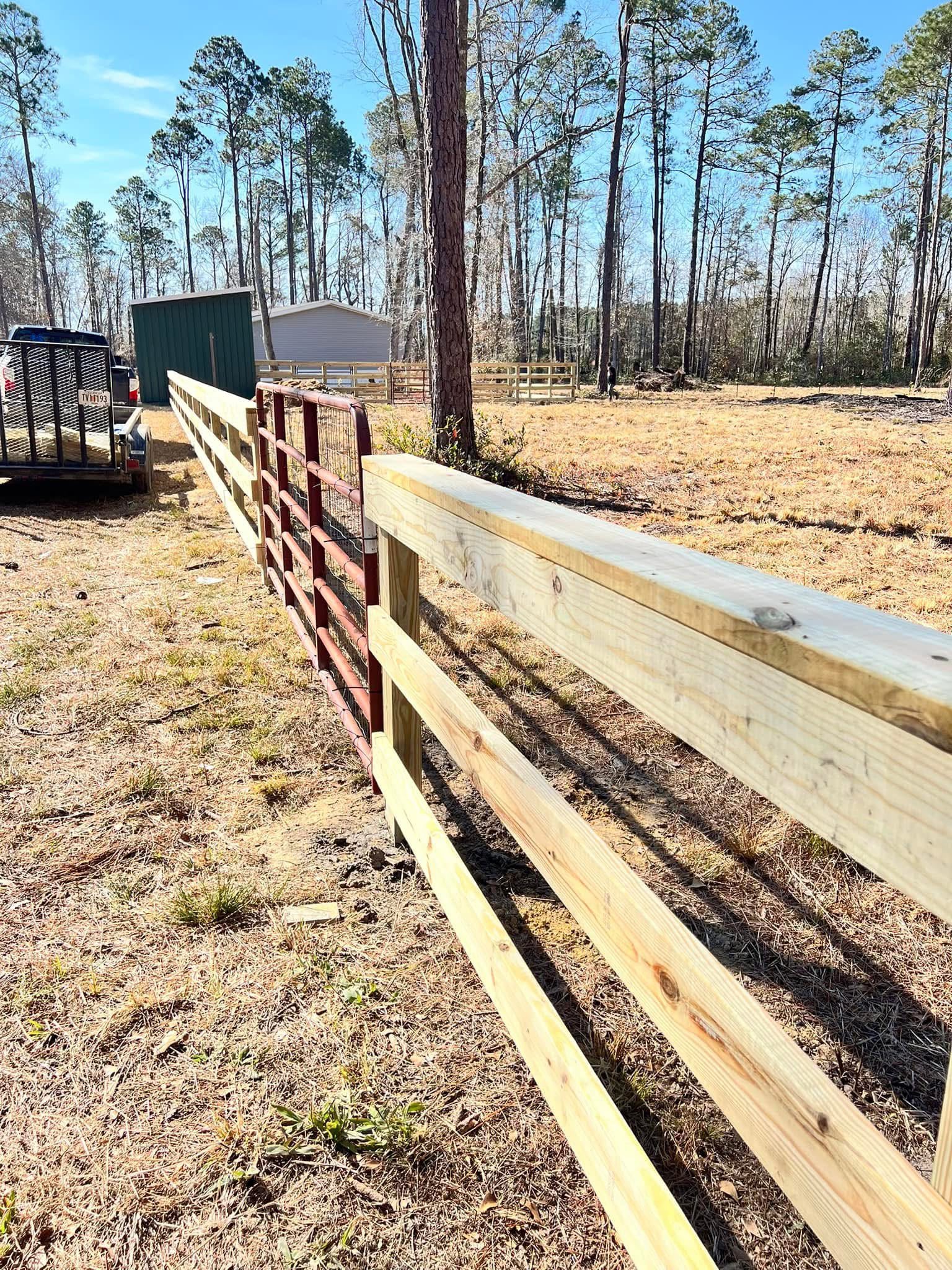 Multi-rail ranch fence across open acreage