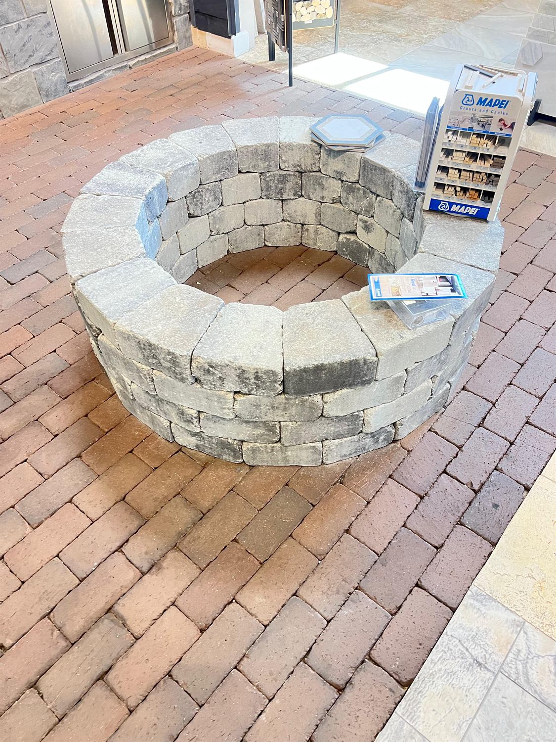 Round fire pit built in tumbled block, built by Lalo's Home Improvements