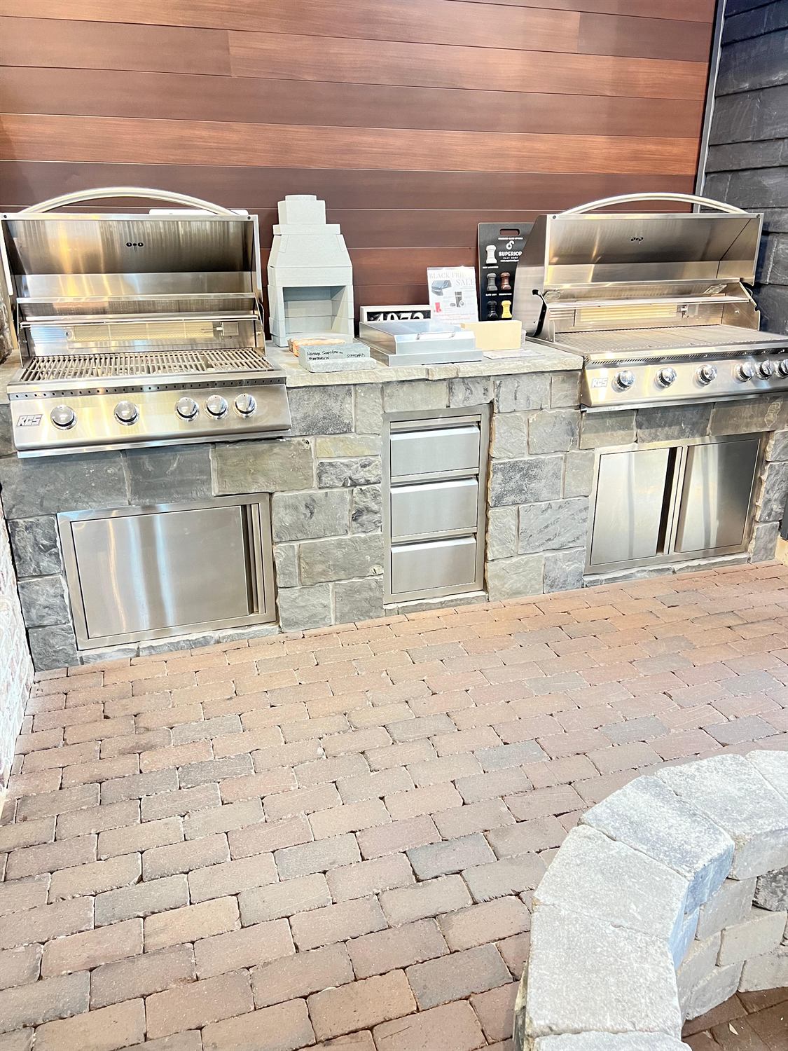 Outdoor kitchen run with two built-in grills and stone veneer, built by Lalo's Home Improvements