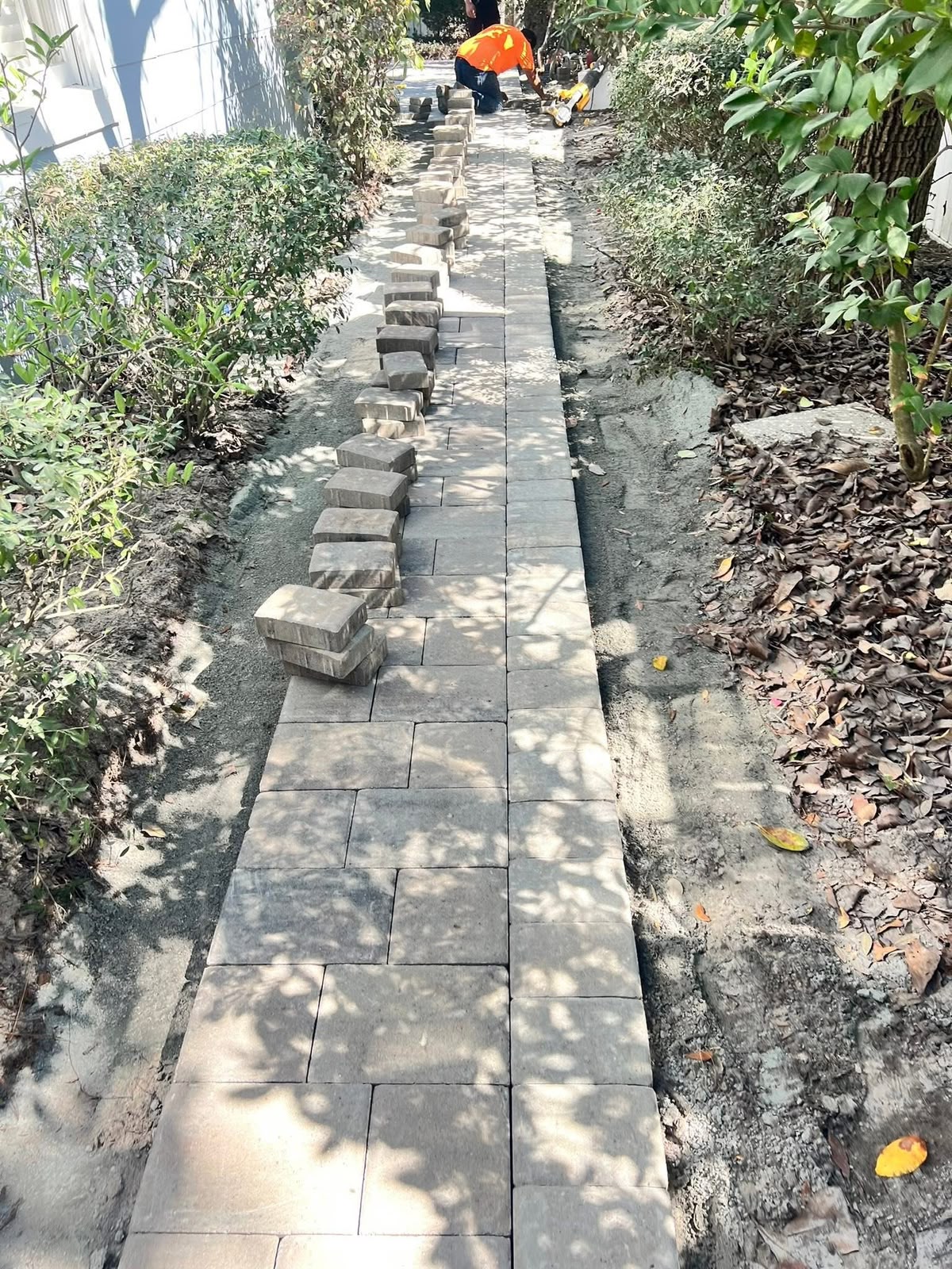 Paver walkway being laid with the border course set first