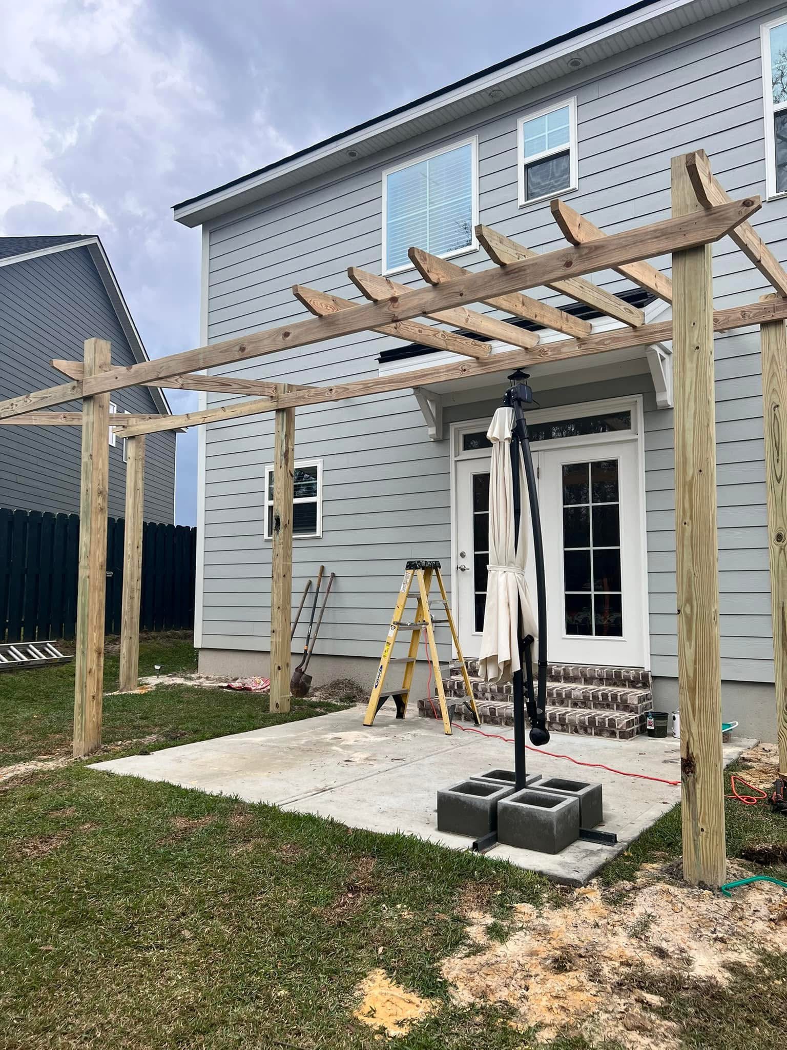 Pressure-treated pergola over a concrete patio