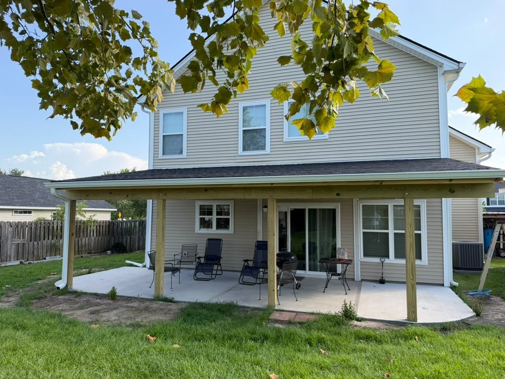 Finished porch framed by a tree from across the lawn