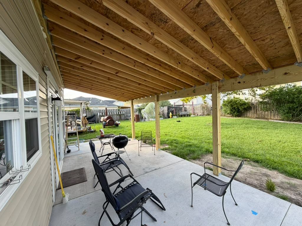 Exposed rafter ceiling under a custom porch cover